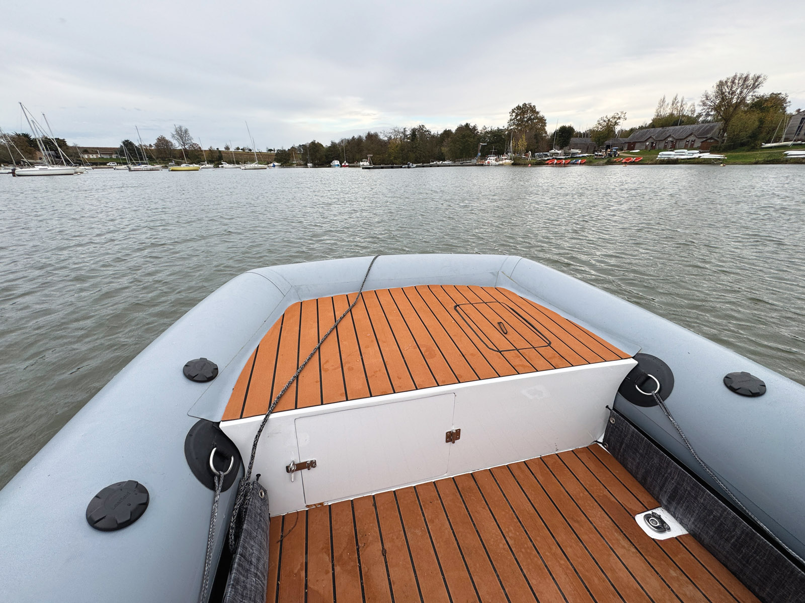 The AXCat features a very comfortable deck covering. Note the numerous storage spaces (lockers and fabric storage compartments) and the sturdy anchoring points.