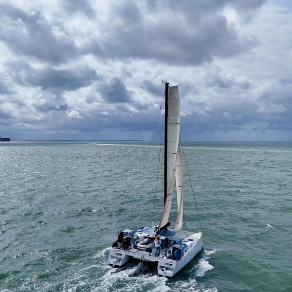 This view clearly shows the significant volume offered by the hulls. Note that the central cockpit is so large that it can readily accommodate the dinghy!