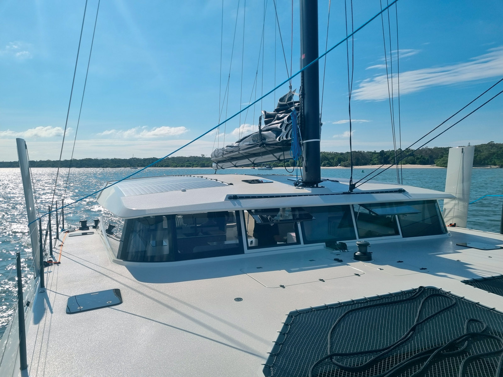 Low profile topsides, hidden lines and slim hulls minimize windage on the Cure 55.