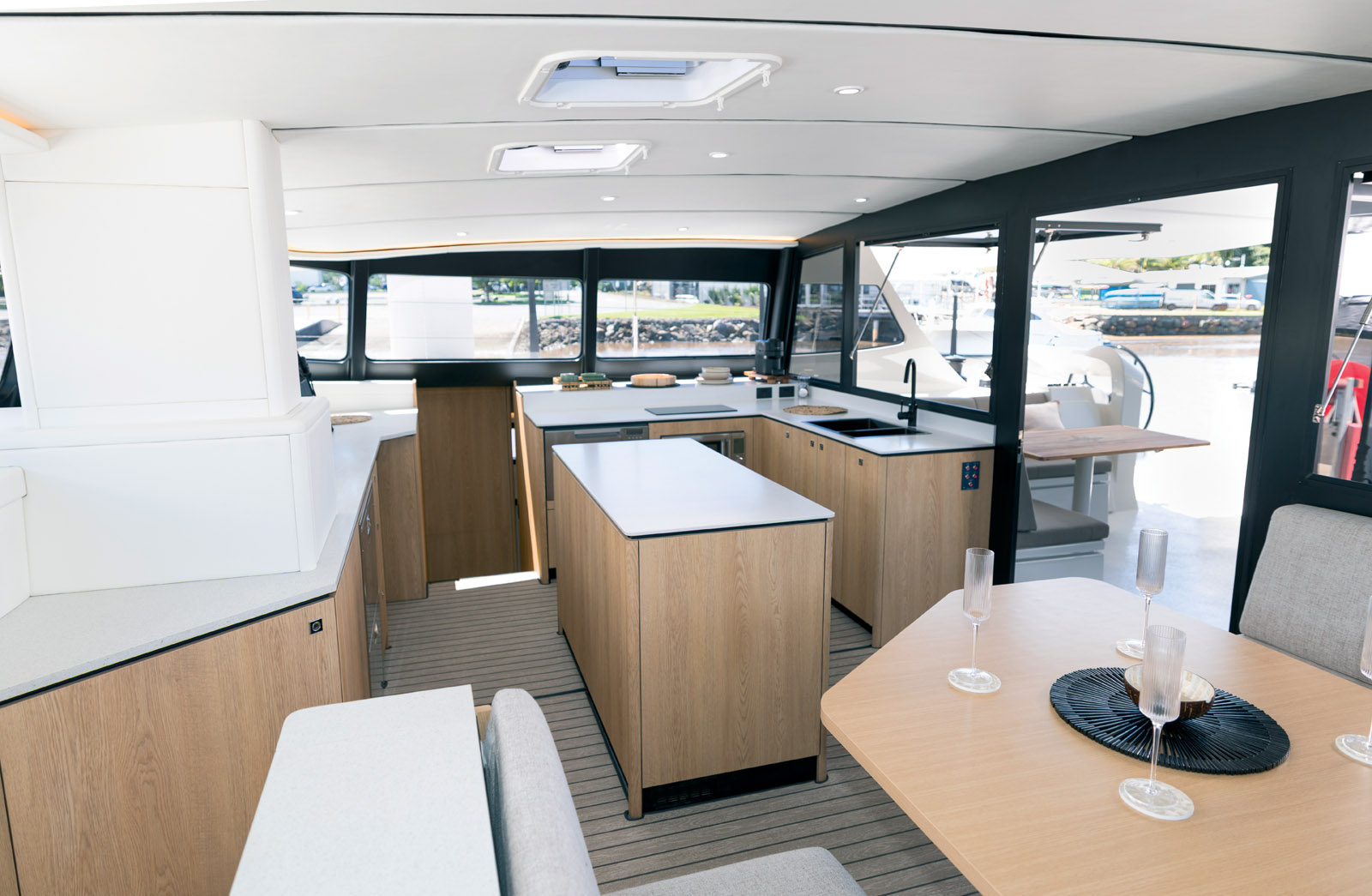 Offset to starboard, the vast L-shaped galley is completed by a central island.