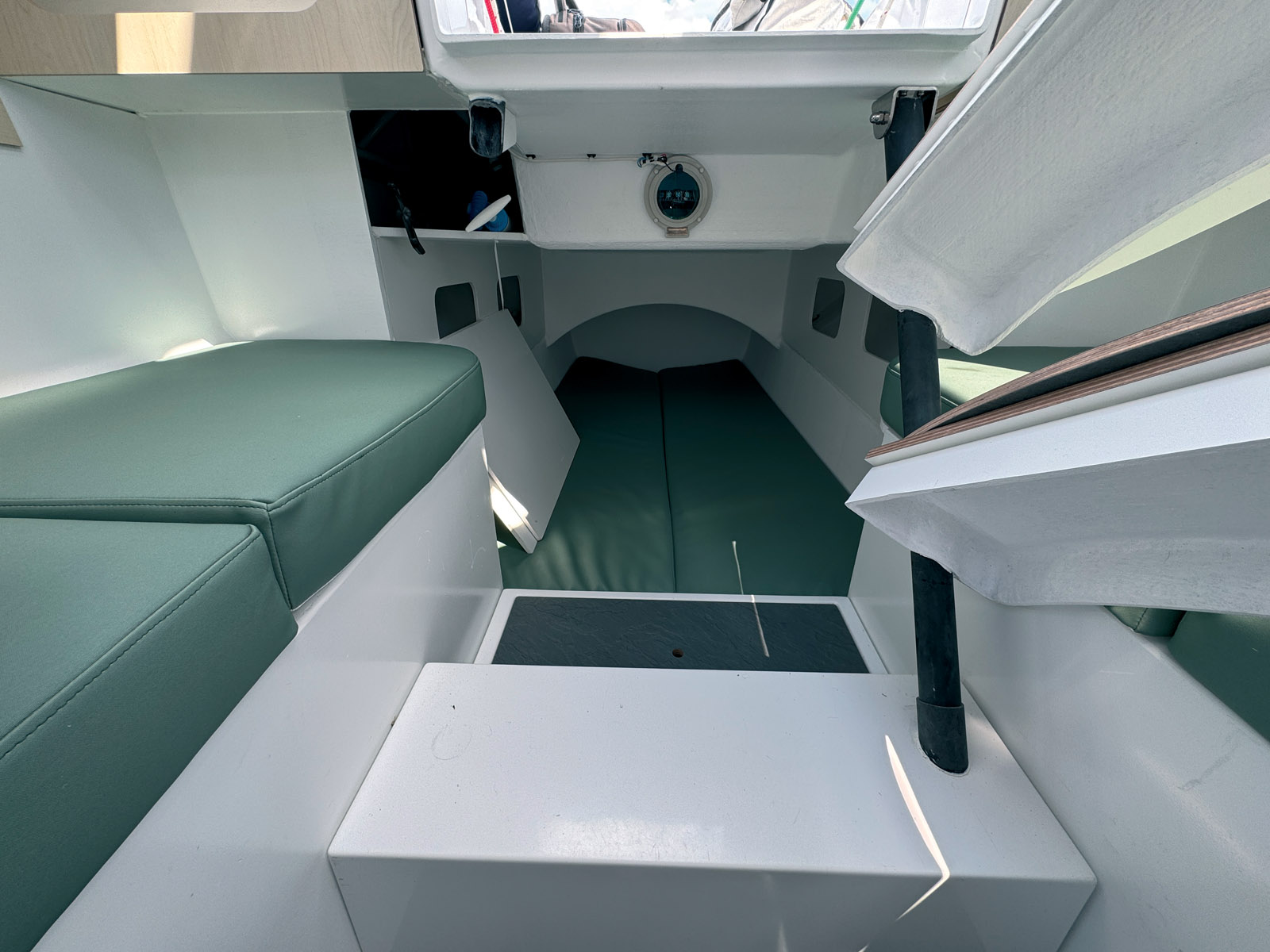 The companionway ladder doubles as a seat and swivels to allow access to the aft berth.